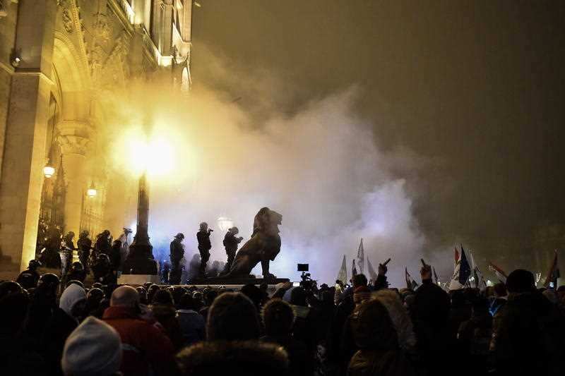 Protesters clash with police during a demonstration outside Budapest’s parliament building, against amendments to the labour code