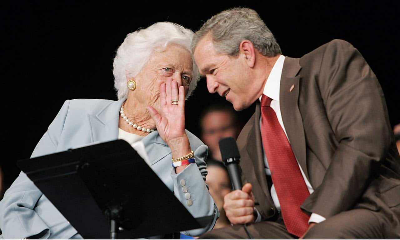 US President George W. Bush (R) listens to his mother, Former First Lady Barbara Bush