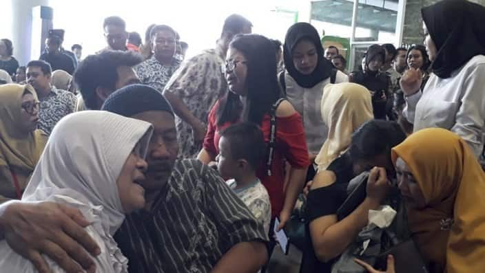 Relatives of passengers comfort each other as they wait for news of the Lion Air plane.