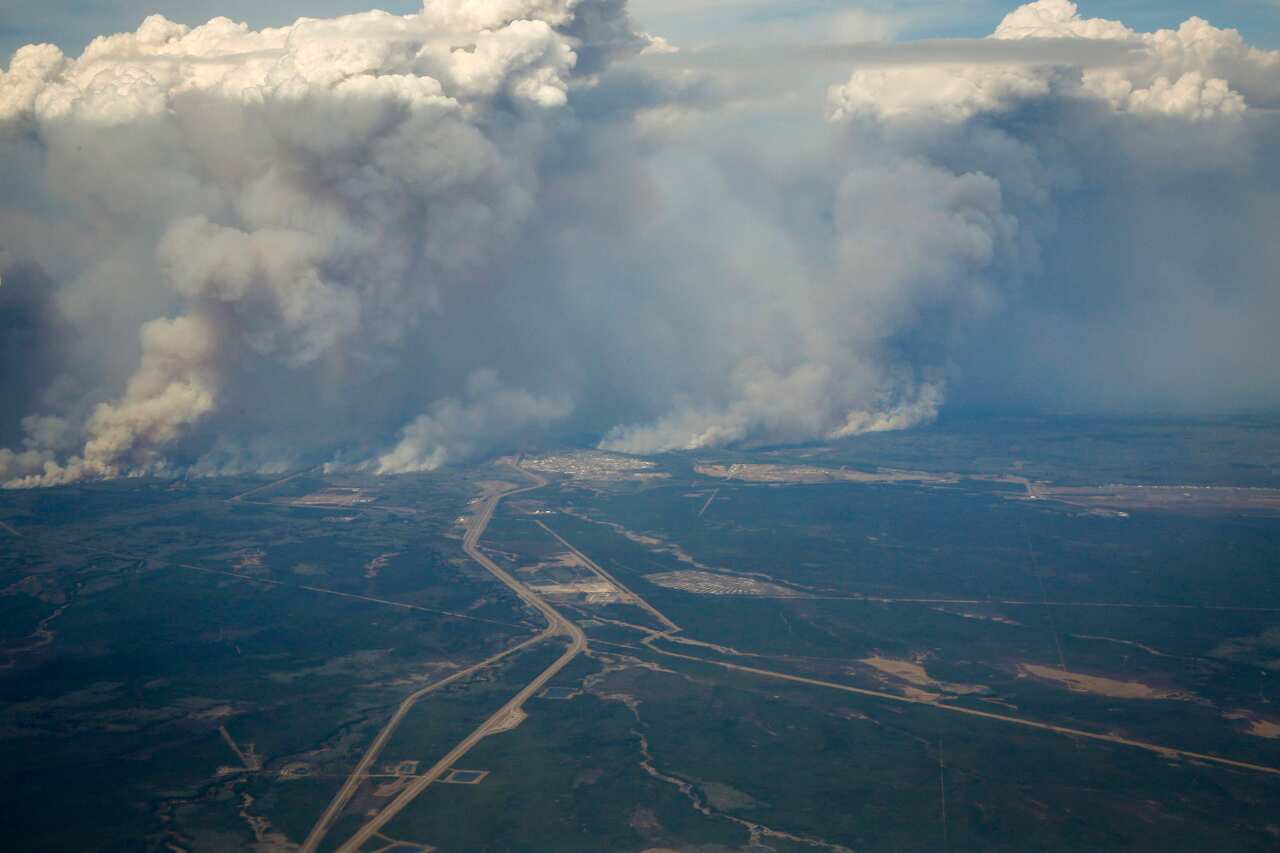 Smoke billows into the air as wildfires burn in and around Fort McMurray (AAP)