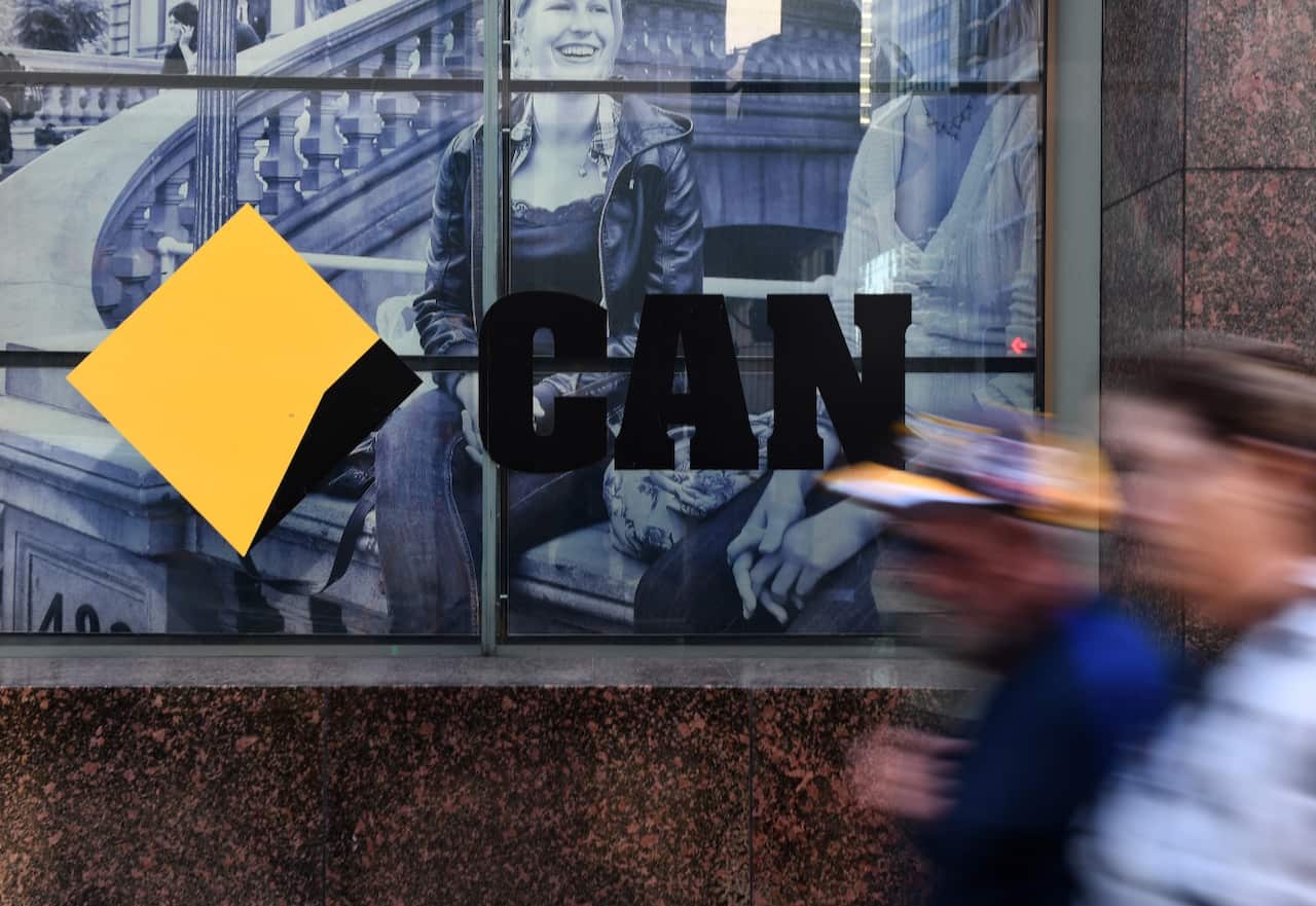 CBD workers walk past the a Commonwealth Bank of Australia branch in Sydney, Monday, June 4, 2018. The CBA has a reached a $700 million dollar settlement 