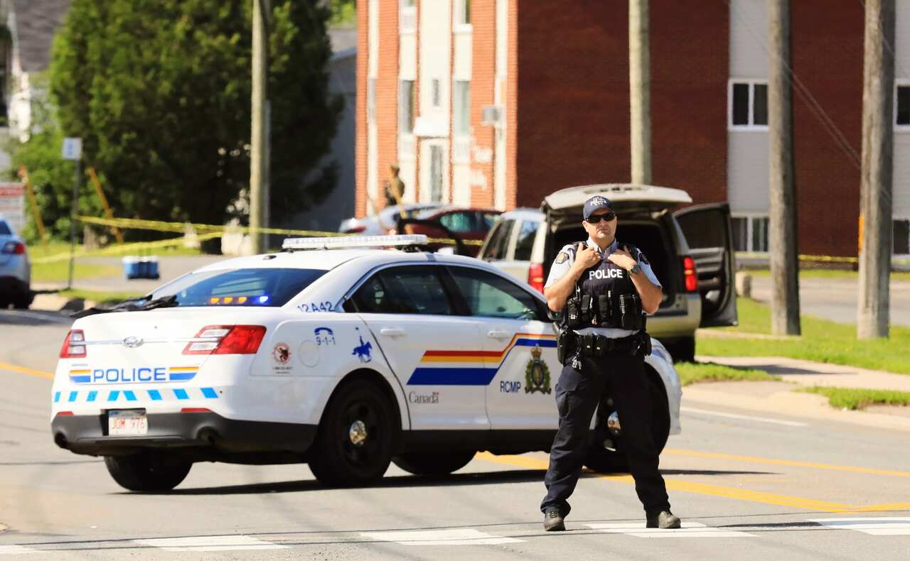 A police officer blocks the area of a shooting in Fredericton, New Brunswick, Canada