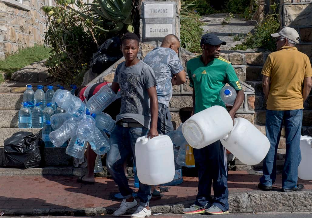 People queue to collect water from a natural spring in Cape Town, South Africa.