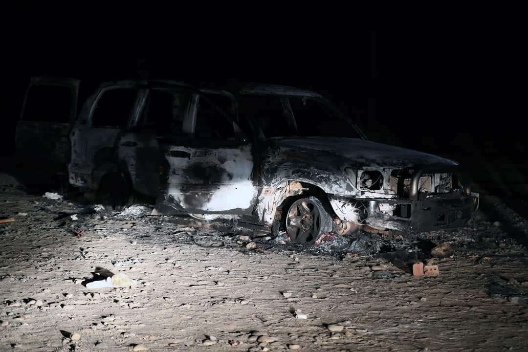 A burnt-out car, reportedly used by gunmen in an attack on a bus carrying Coptic Christians.