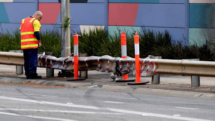 Police examine the scene where the two cars collided.