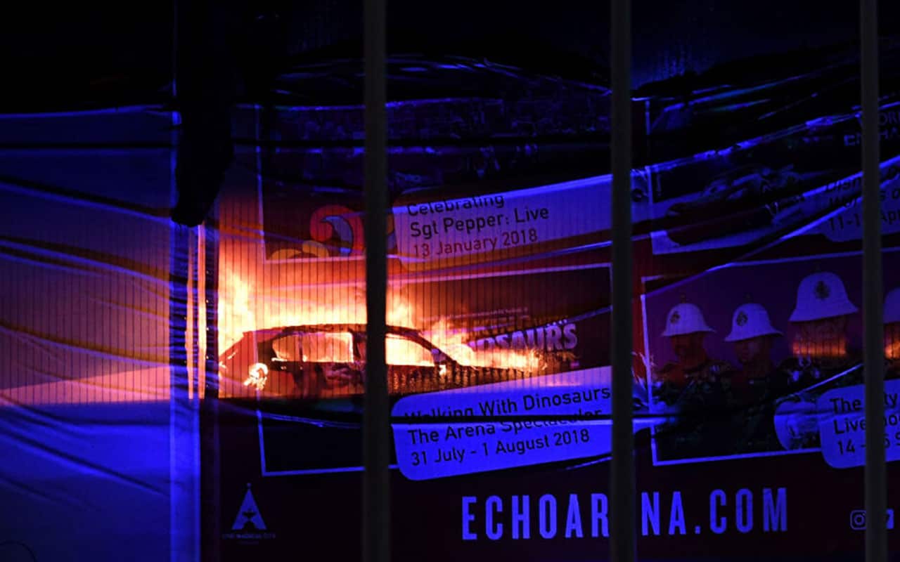Cars burn during a blaze engulfing vechiles parked at a multi-storey car park near the Echo Arena, at the waterfront in Liverpool.