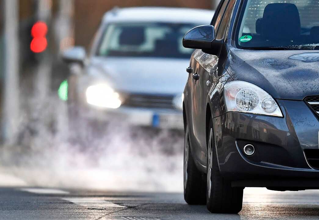 Two cars drive towards the camera.