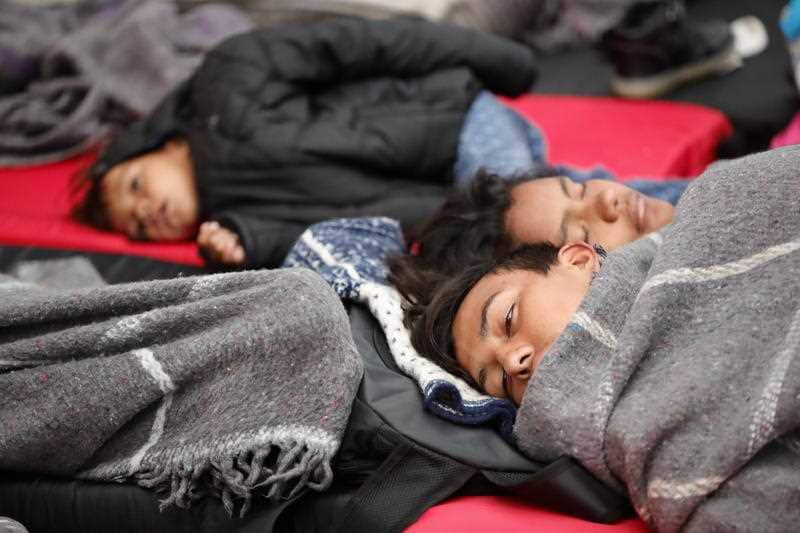 People of the migrant caravan rest in the sports center Jesus Martinez Palillo, in Mexico City.