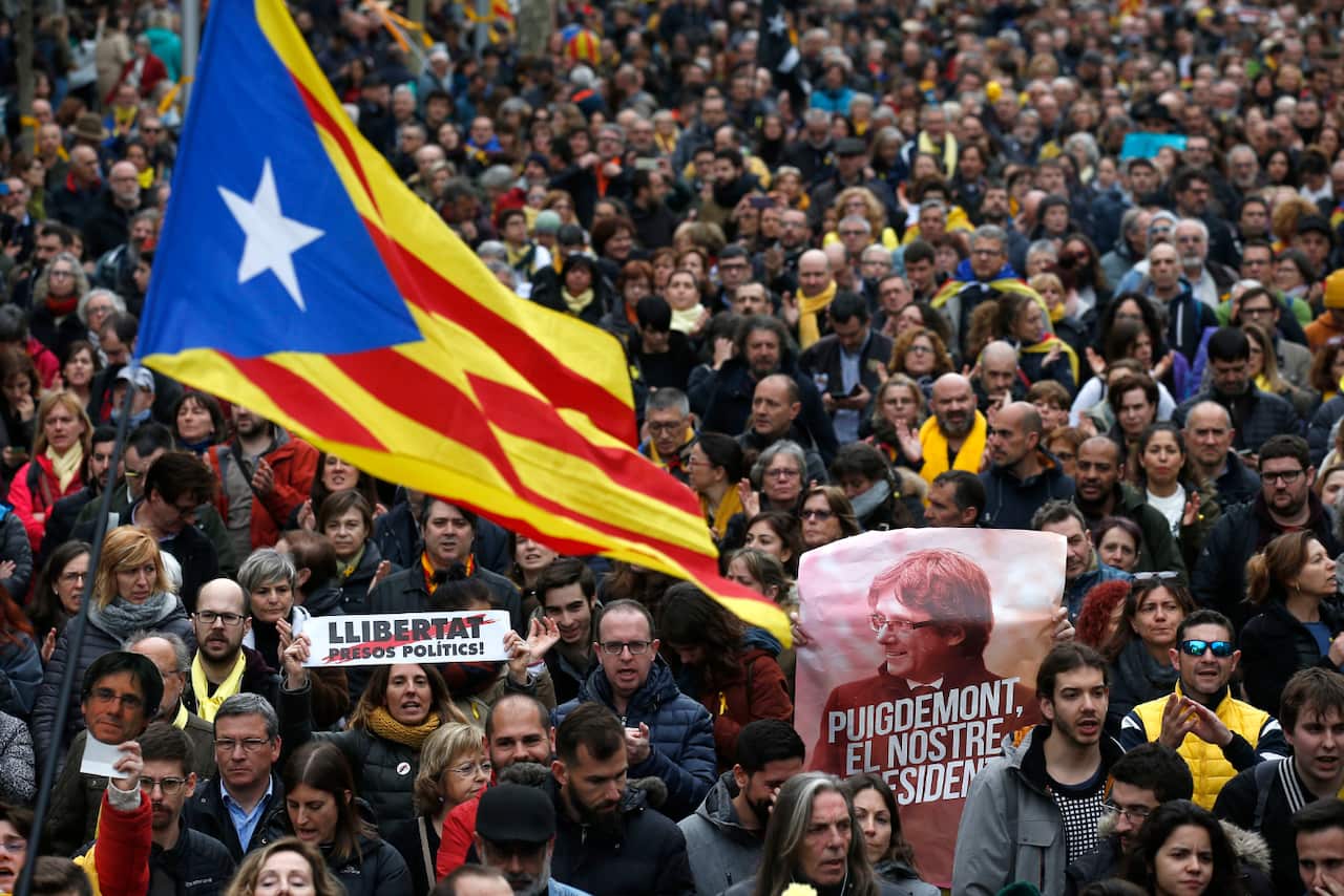 Protesters in Barcelona carried Catalonia flags and posters reading "Puigdemont, our President". 
