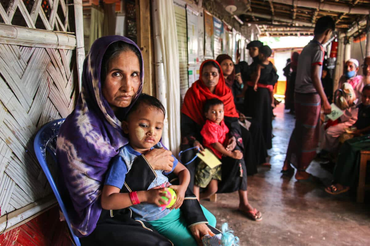 Woman with child she gave birth to during her journey to Bangladesh