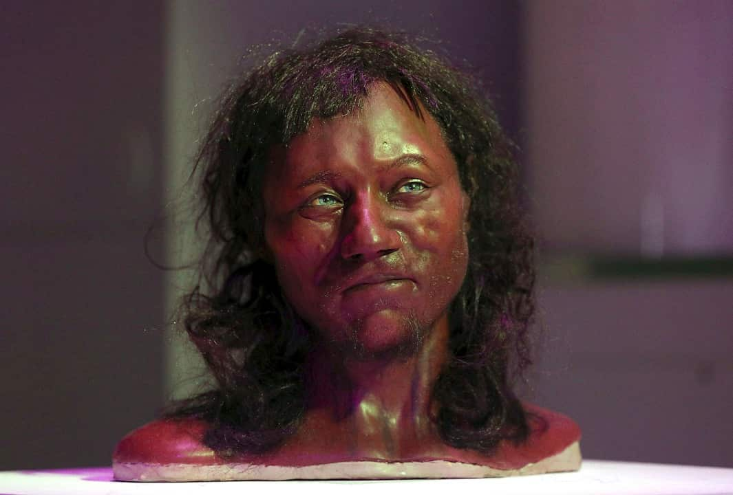 DNA from a 10,000-year-old skeleton found in an English cave suggests he had dark skin and blue eyes.