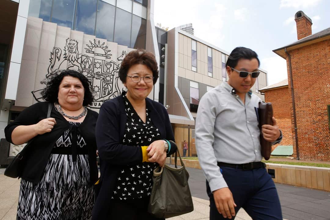 Curtis Cheng's son Alpha Cheng (right), and widow Selina Cheng (centre) leaving court. 