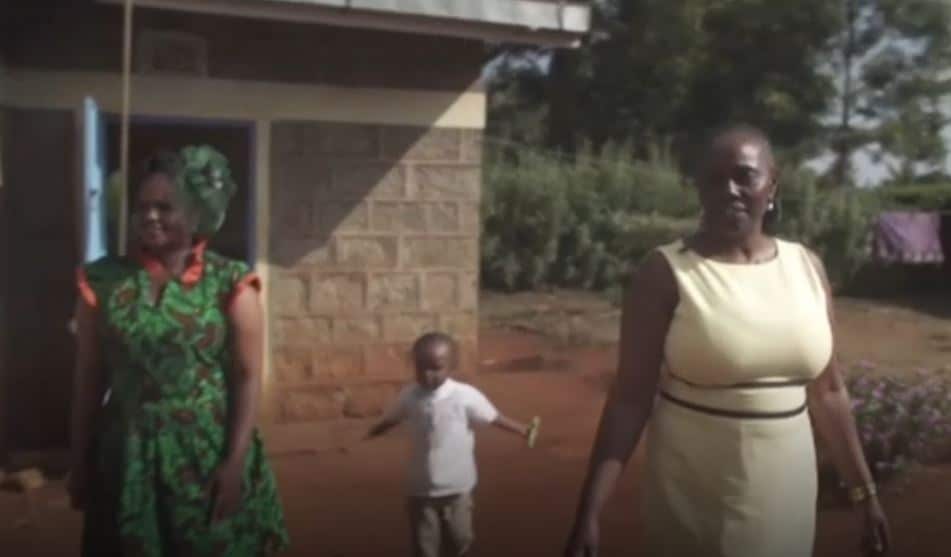 Lucy Gichuhi, right, outside her childhood home.