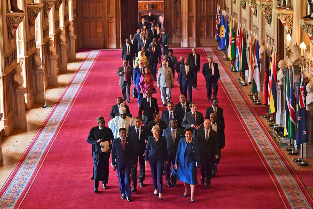 Britain's Prime Minister Theresa May, front centre, leads other leaders of the Commonwealth nations through St George's hall at Windsor Castle.