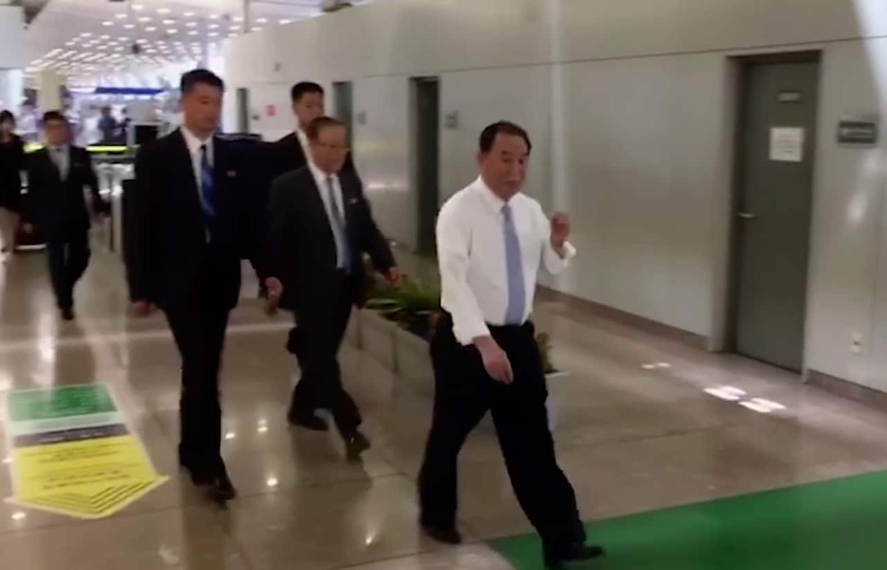 In this image made from video, Kim Yong Chol, in white,is seen at Beijing airport.