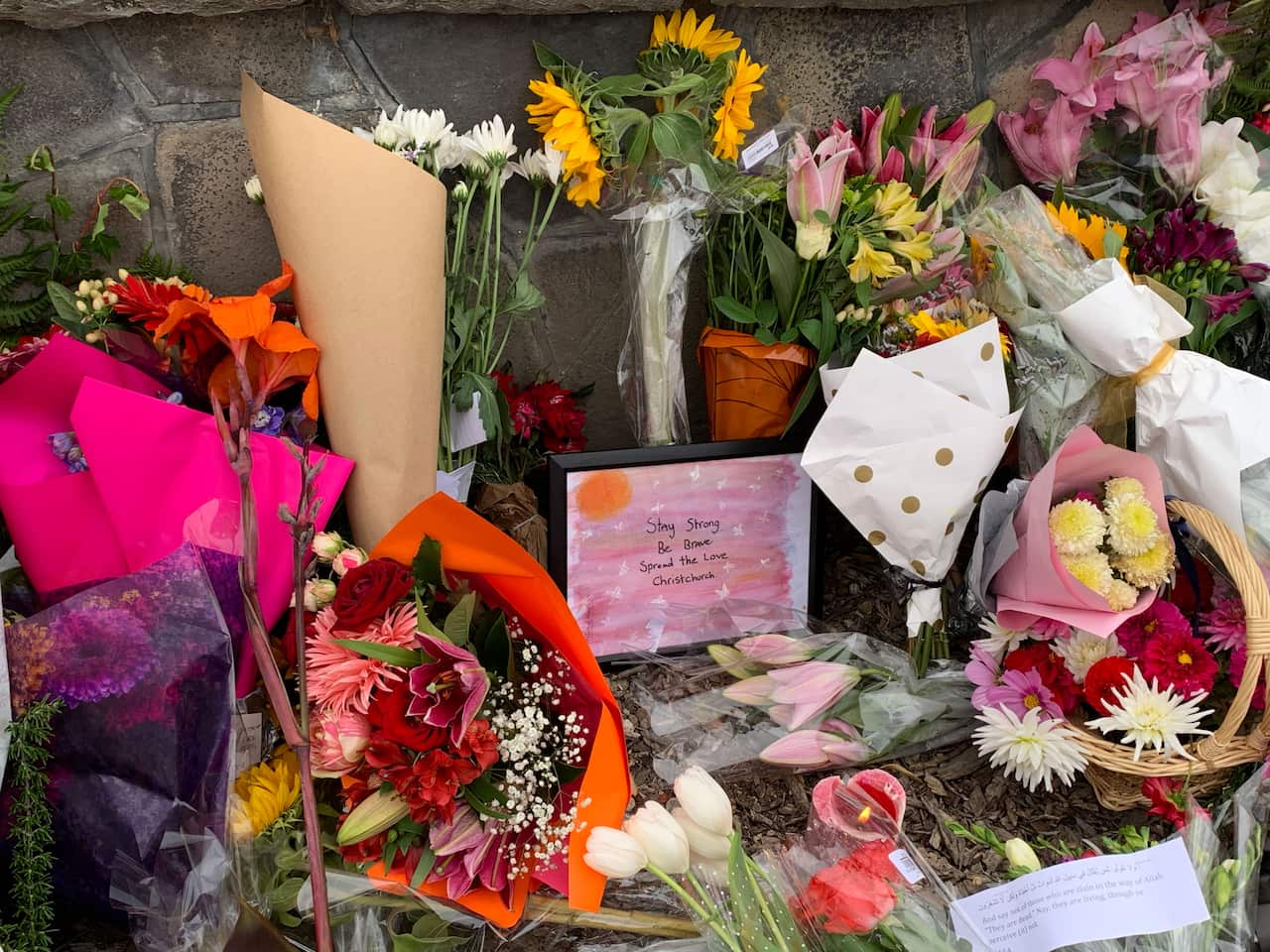 Messages of support have been left with flowers at the memorial