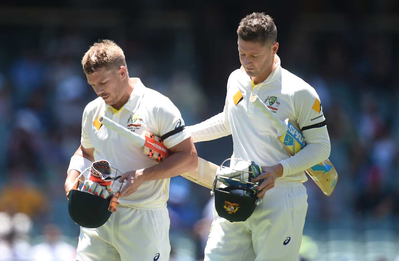 Australian cricketers David Warner (left) and Michael Clarke leave the field at lunch on day 1 of the first Test match between Australia and India at the Adelaide Oval in Adelaide, Tuesday, Dec. 9, 2014. (AAP