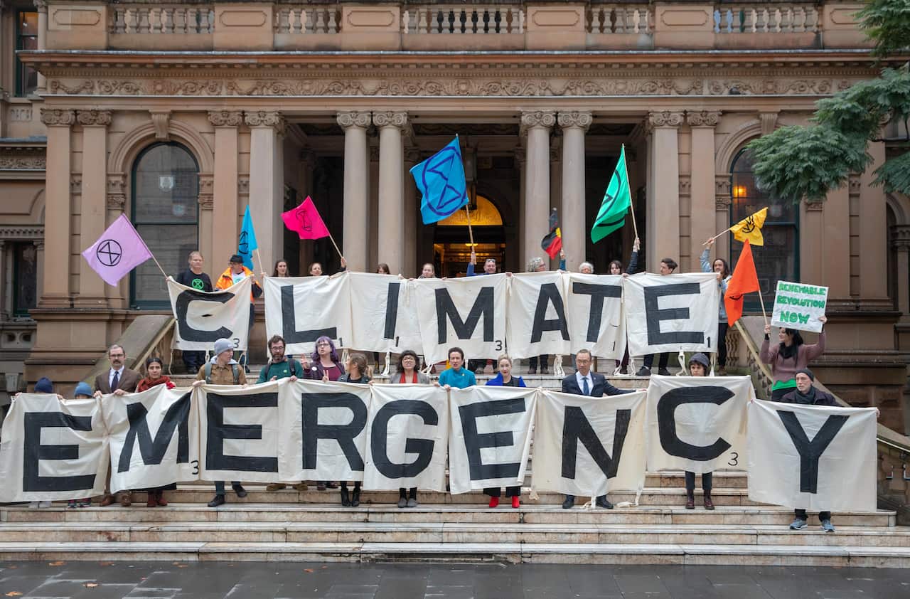 Activists from the Extinction Rebellion, Lord Mayor Clover Moore, Councillor Jess Miller, Councillor Jess Scully and Councillor Robert Kok at Sydney Town Hall.