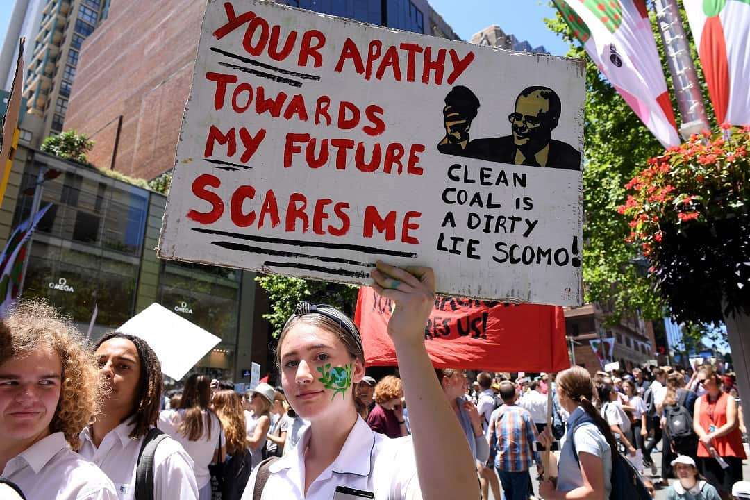 Saskia Cook-Knowles of Port Kembla High School holds a placard as thousands of students rally demanding action on climate change, in Sydney, Friday, November 30, 2018.