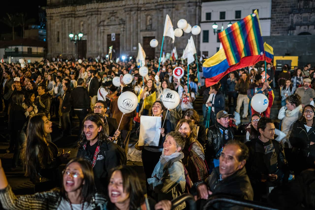 People in Bogota celebrate the peace agreement between the government and the Revolutionary Armed Forces of Colombia, known as the FARC, on Sept. 26, 2016. 