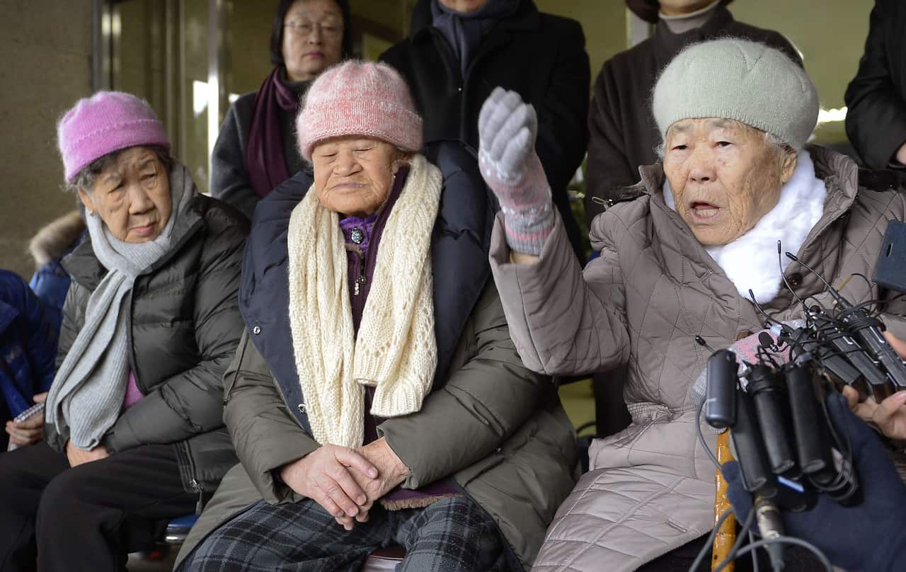 Women who worked at Japanese wartime brothels speak to reporters in January.