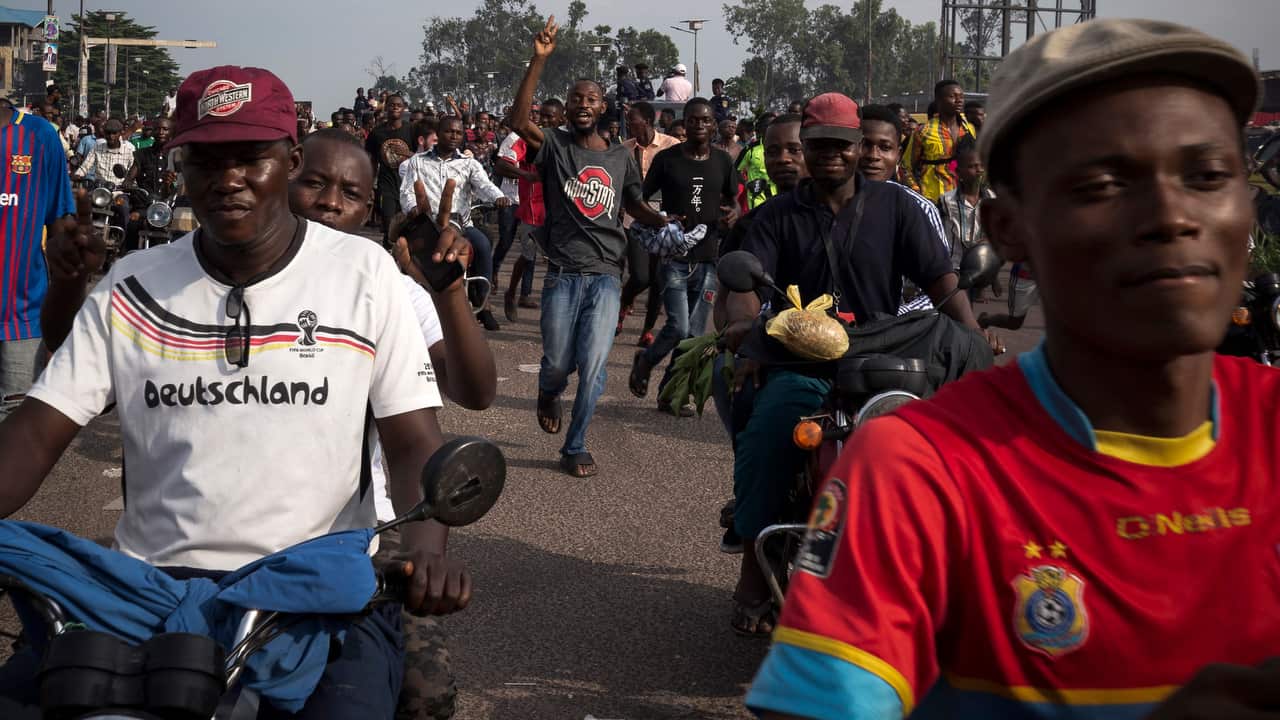 Supporters of the opposition candidate Felix Tshisekedi celebrate after Tshisekedi cast his ballot.