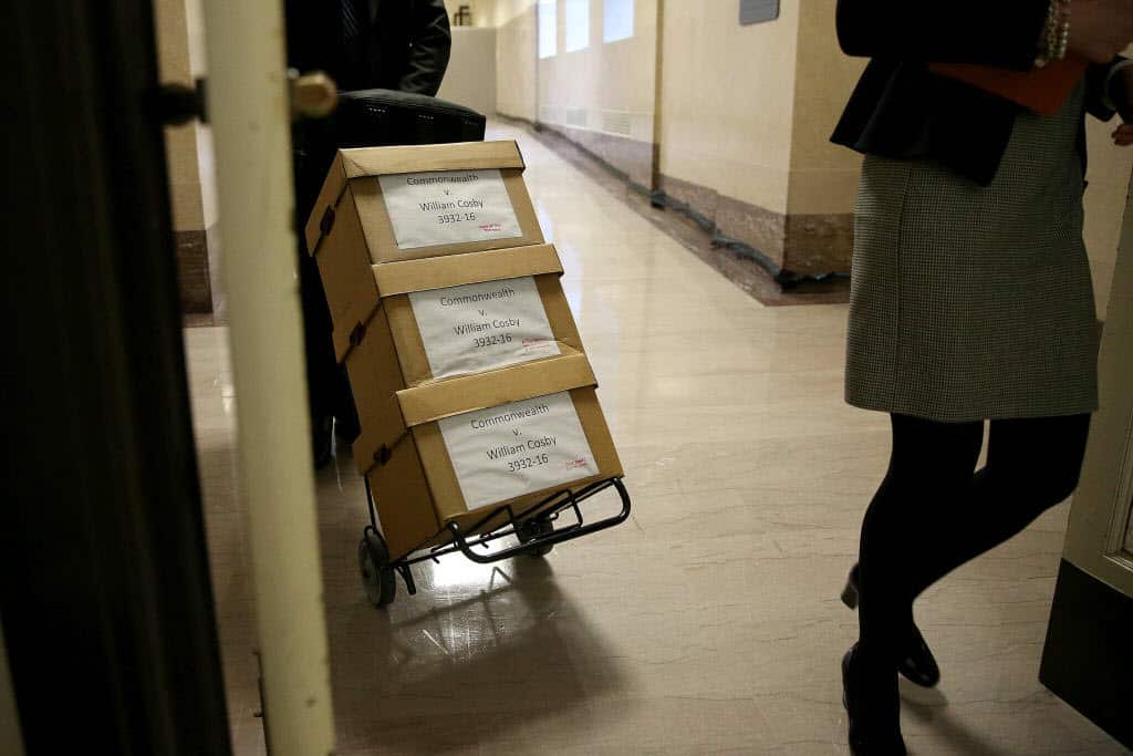 Files for the prosecution's case against actor and comedian Bill Cosby are wheeled into the courtroom.