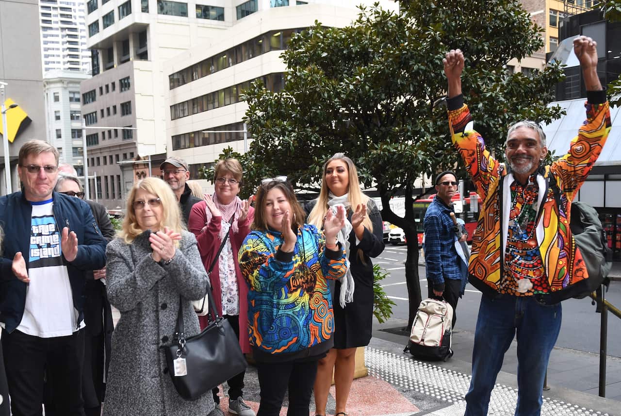 Supporters, including Mark and Faye Leveson applaud as Mr Jubelin arrives at Downing Centre Courts.