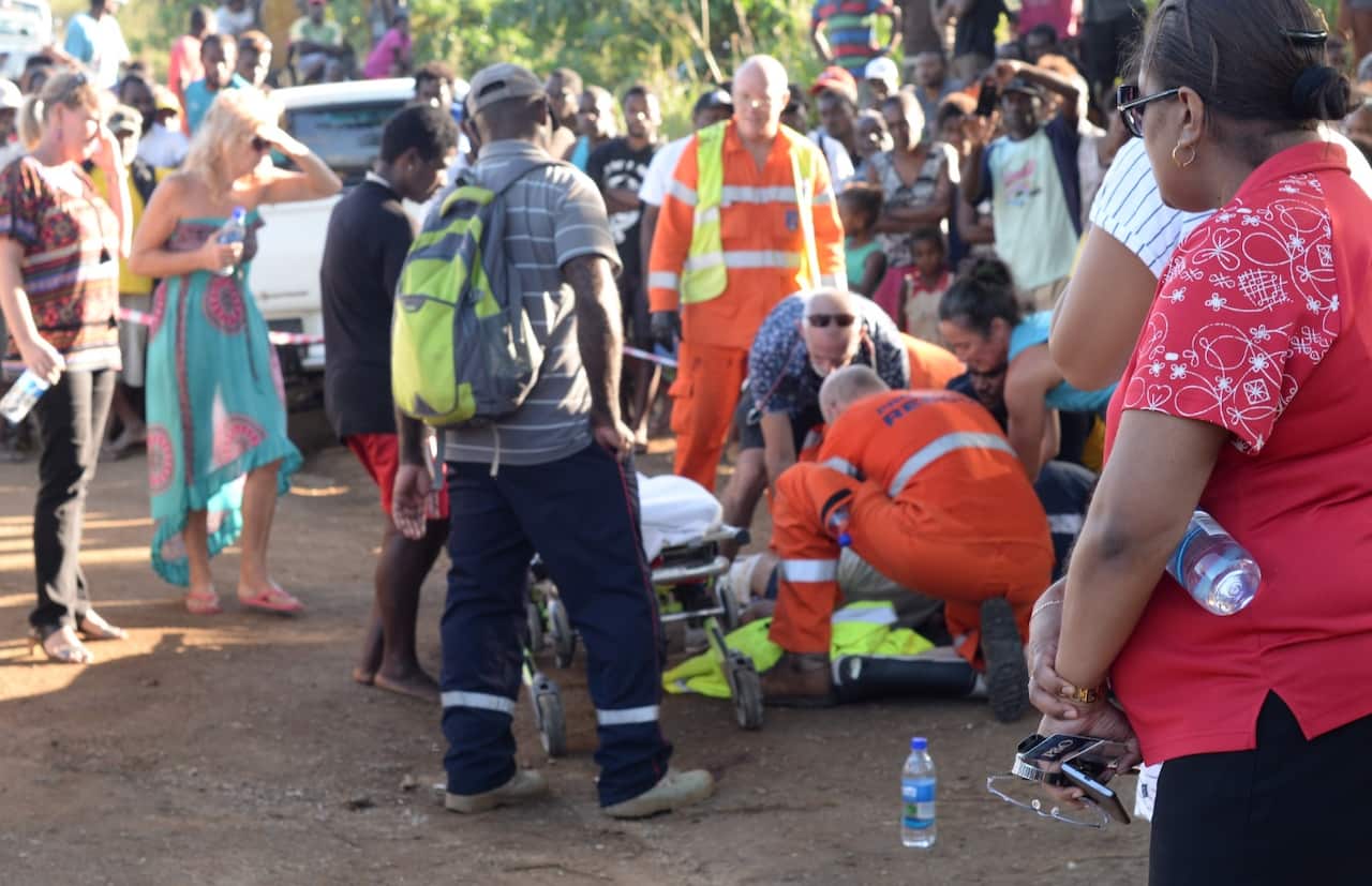 Emergency staff tending to people following the bus crash in Vanuatu's capital of Port Vila (AAP)