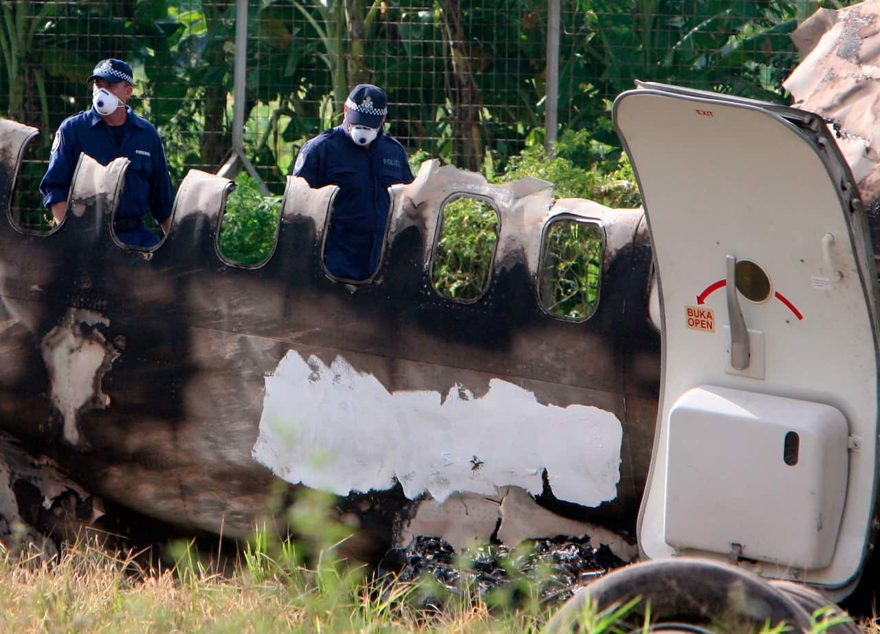 Australian Federal Police take part in the investigation at the crash site of the wrecked Garuda Boeing 737 plane at Adisucipto airport in Yogyakarta in 2007.