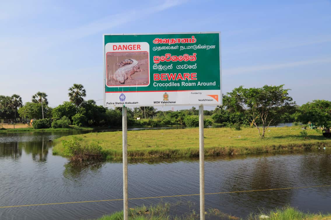 Danger sign warning of crocodiles, Pasikudah Bay, Eastern Province, Sri Lanka 