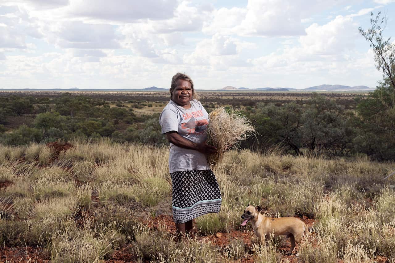 Cynthia Burke from Warakurna, WA, collecting materials for weaving.