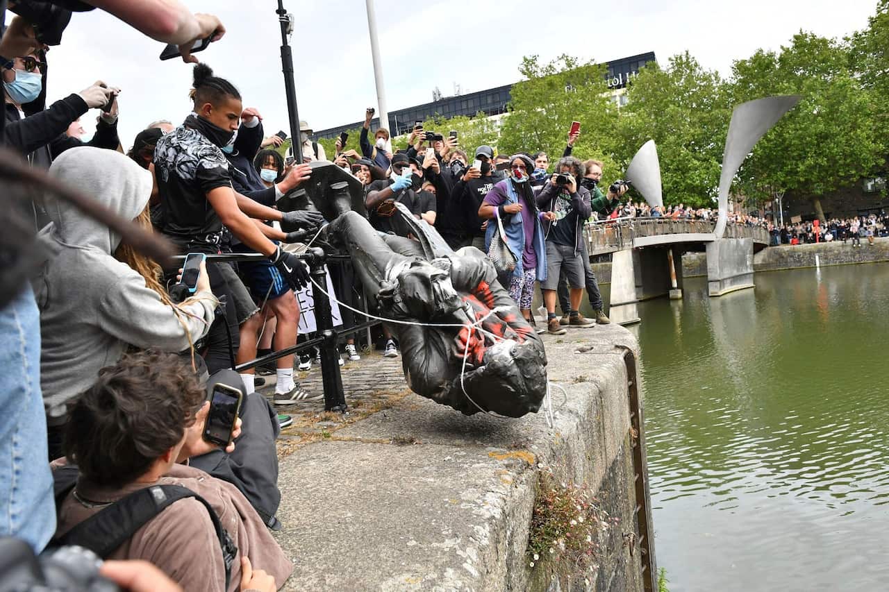 Protesters throw the statue of slave trader Edward Colston into Bristol Harbour.