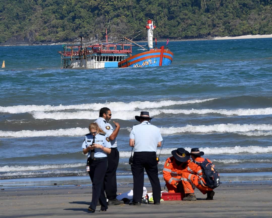 The sunken fishing boat lies off the beach at Cape Kimberly at the mouth of the Daintree River where suspected Vietnamese migrants came ashore.