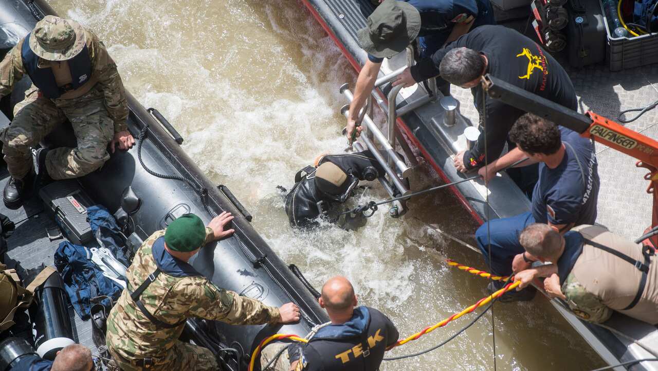 A diver prepares to dive to the wreckage under Margaret Bridge, the site of the accident involving South Korean tourists, in Budapest.