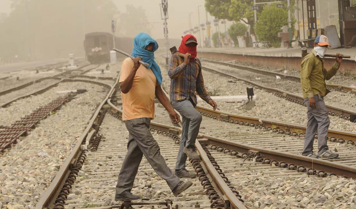 Trackmen covering the face during the dusty and humid weather.