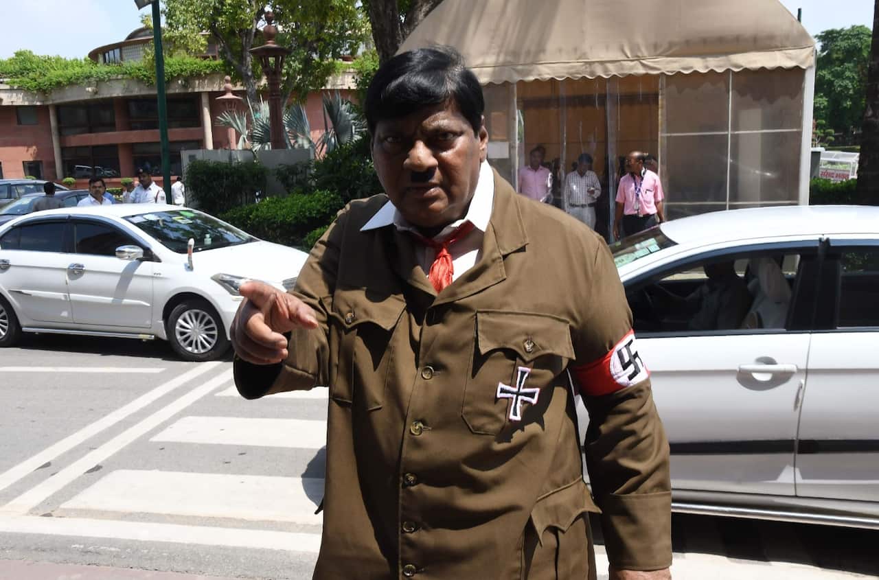 Indian film actor turned politician Naramalli Sivaprasad, arrives at parliament dressed as Adolf Hitler