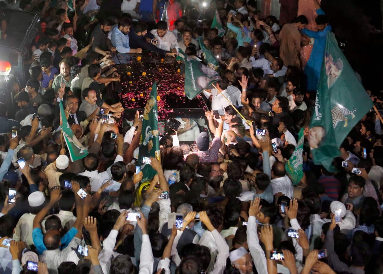 A vehicle carrying former Pakistani Prime Minister Nawaz Sharif is surrounded by his supporters following his release from prison