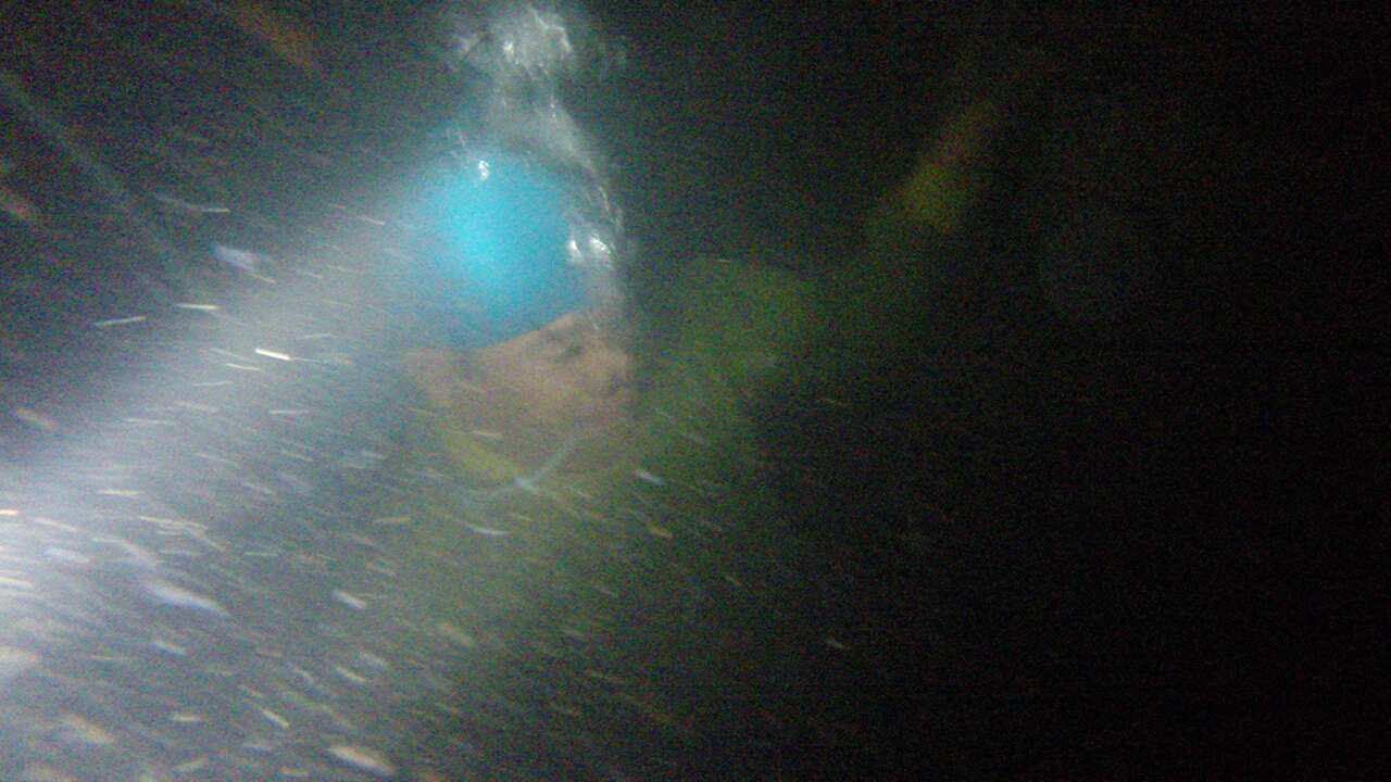 Evan got rare access to film the miners descending into the underwater gloom.