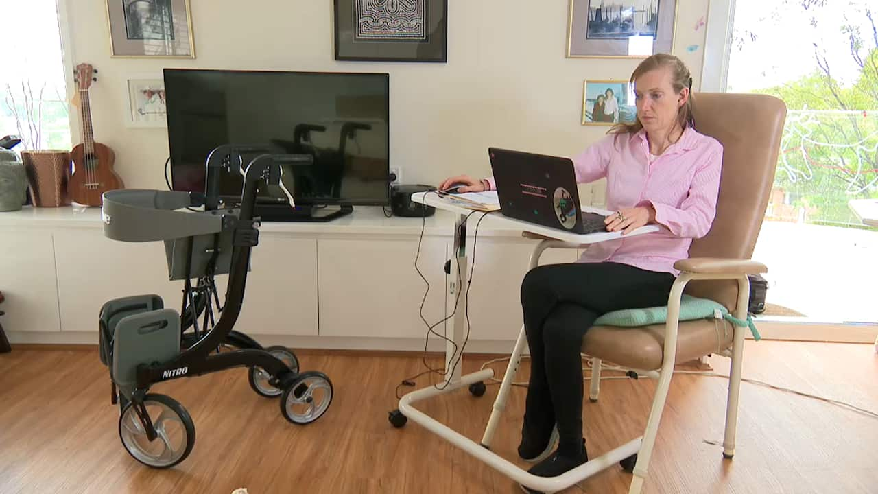 Katherine Gill working on a laptop in her home