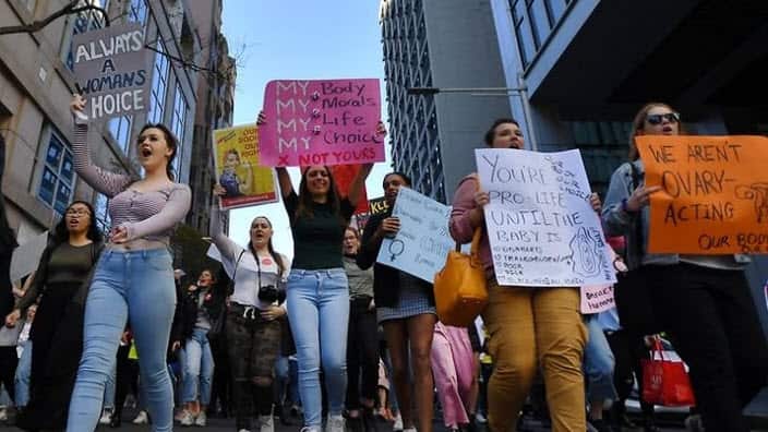 Protesters have marched in Sydney against abortion laws in the United States and NSW. (AAP)
