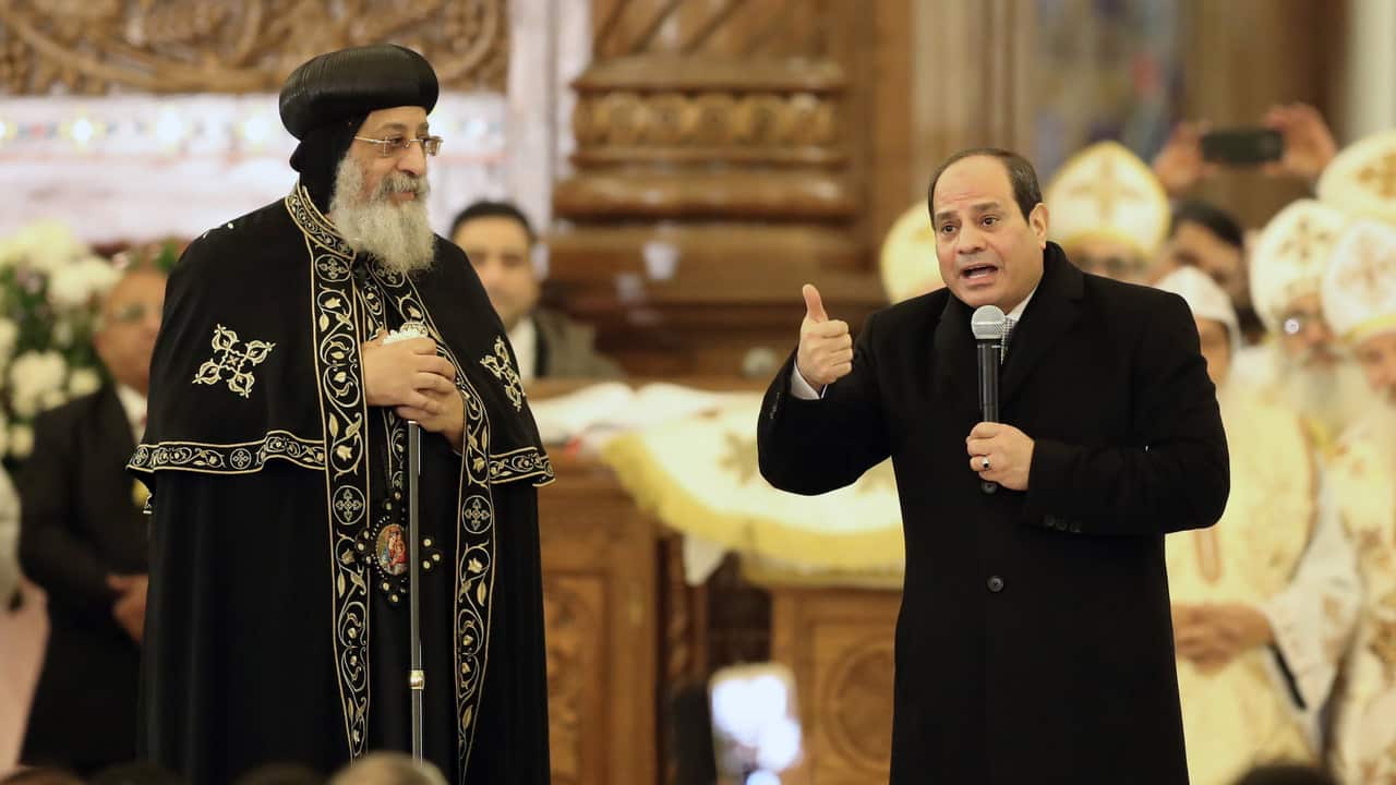 Pope Tawadros II of Alexandria listens as Egyptian President Abdel Fattah al-Sisi speaks before mass at the newly inaugurated Cathedral of Nativity.