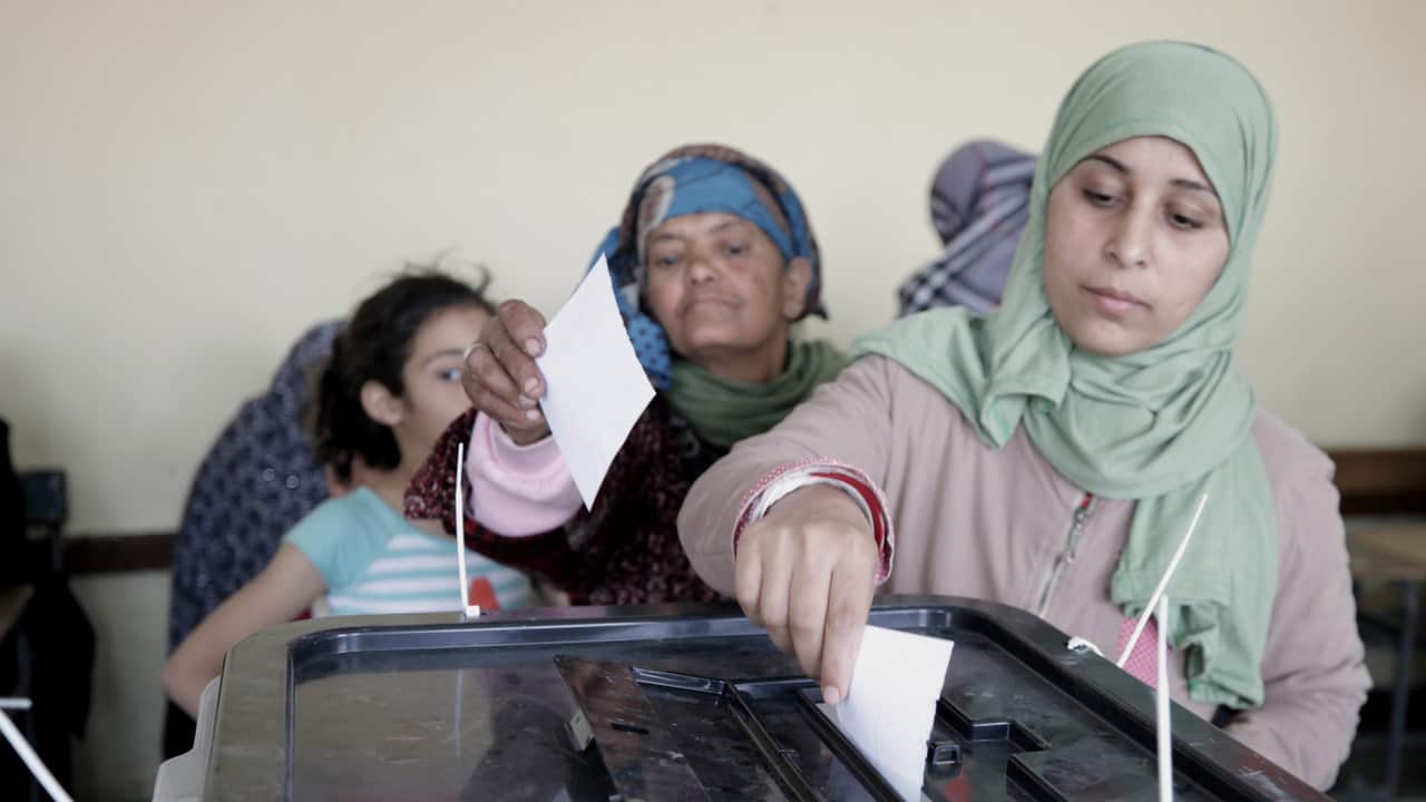 A woman casts her vote during the referendum on draft constitutional amendments, at a polling station in Cairo.