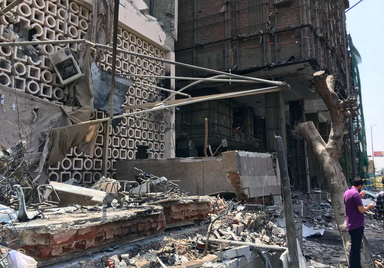A view of the damaged facade of the National Cancer Institute after an overnight fire from a blast.