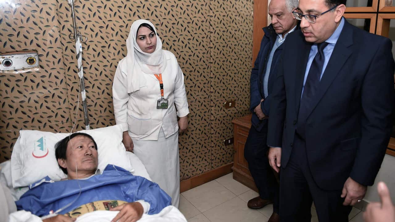 Egypts Prime Minister Moustafa Madboulyvisits a Vietnamese injured at a hospital  after a bomb explosion, near Mariottia Corridor, Giza, Egypt.