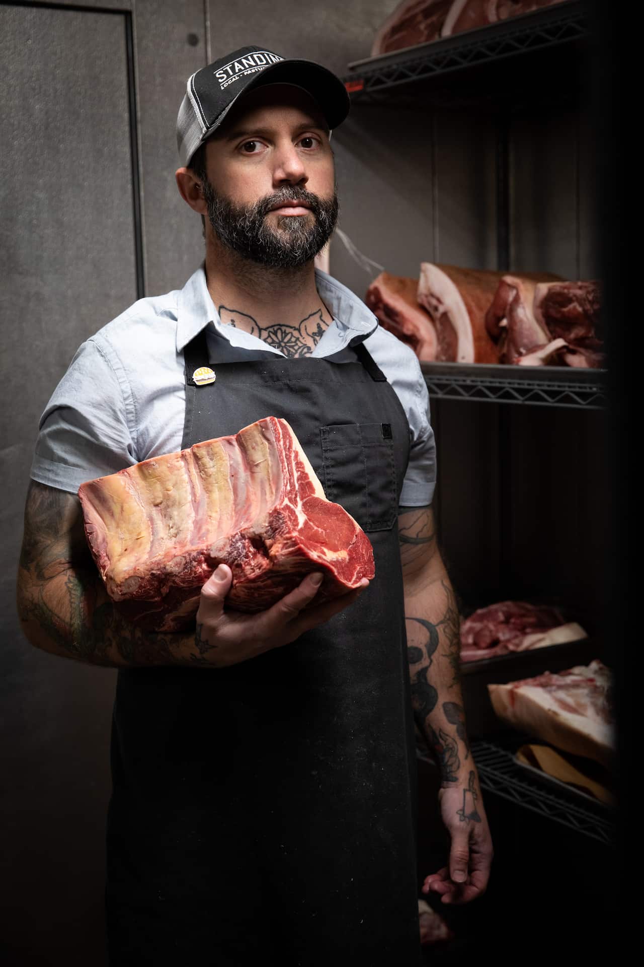 Jered Standing holds a beef rib roast in the walk-in refrigerator of his store, Standing’s Butchery, in Los Angeles, July 29, 2019. Standing eschewed meat after working as a conventional butcher in a supermarket because he was turned off by what he saw, b