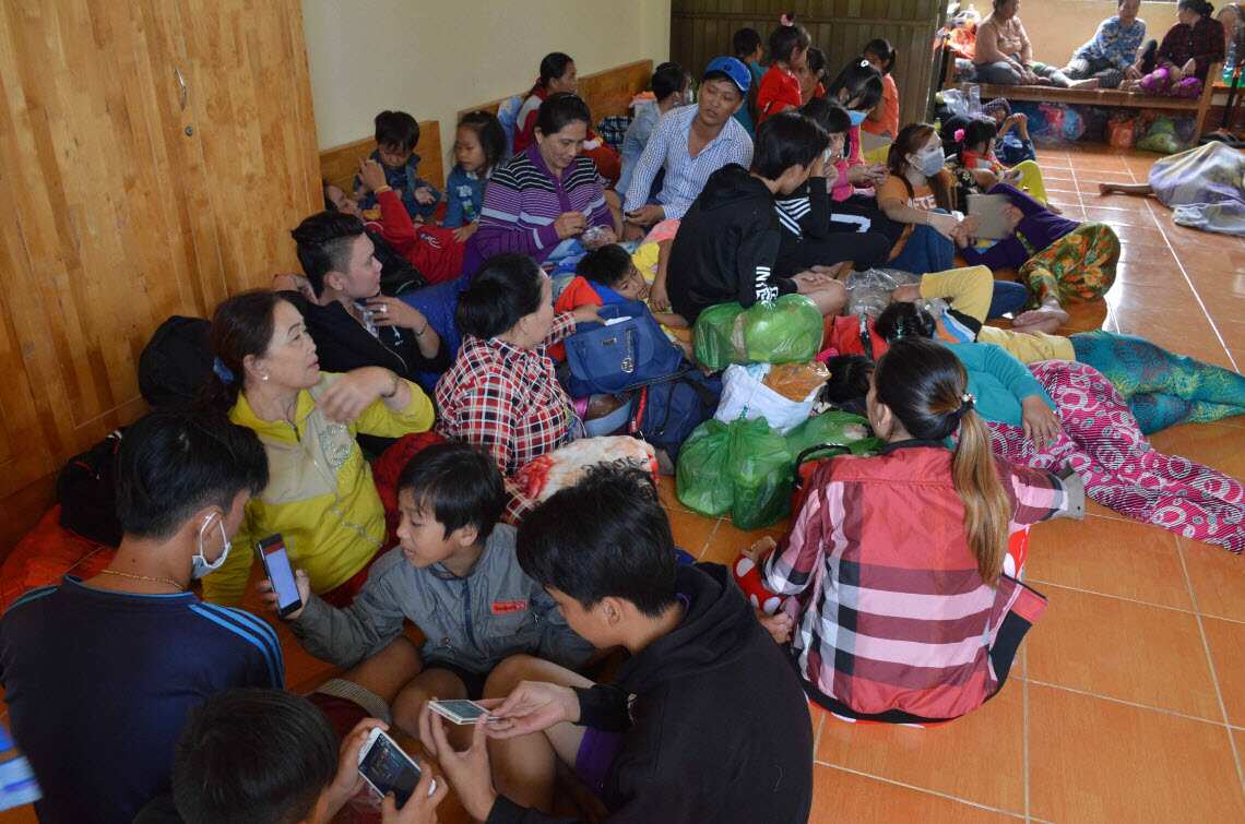 People gather inside an evacuation center in Vietnam as typhoon Tembin approaches.