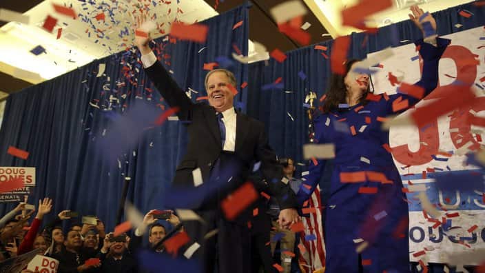 Democratic candidate for U.S. Senate Doug Jones and his wife Louise wave to supporters before speaking during an election-night watch party Tuesday, Dec. 12, 2017, in Birmingham , Ala. Jones defeated Republican Roy Moore. (AP Photo/John Bazemore)