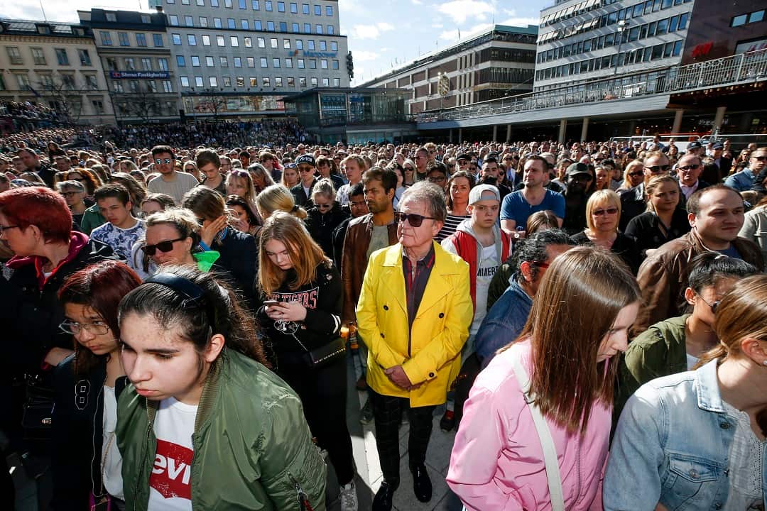 Fans stand for a minute's silence in honour of Avicii.