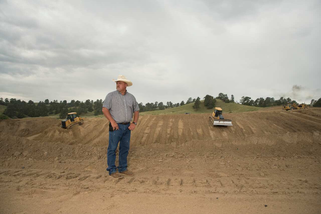 Buz Oliver stands near a failed irrigation canal near Fort Laramie, Wyo., July 27, 2019 (Theo Stroomer/The New York Times)